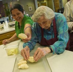 Two women baking dinner rolls